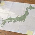 机に広げた日本地図と付箋とペン